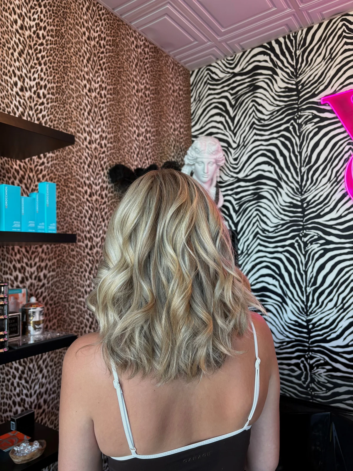 Rear view of shoulder-length blonde highlights with darker dimension